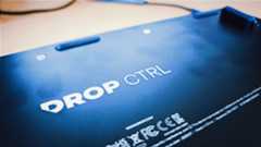 A black Drop CTRL V2 keyboard on a wooden desk