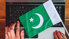 Woman hands and flag of Pakistan on laptop keyboard