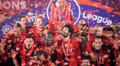 Liverpool players celebrate with the Premier League trophy at Anfield after a 5-3 win over Chelsea behind closed doors in July 2020, with fans not allowed inside the stadium due to the Covid-19 pandemic.