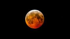 a full red moon on a black background
