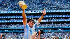 Diego Maradona hoists the FIFA World Cup trophy as he is carried off the field by fans and teammates after the 1986 FIFA World Cup Mexico Final between Argentina and West Germany on June 29th, 1986