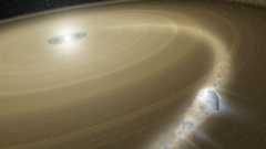 A bright white dwarf star surrounded by golden disks sits in the darkness of space, with a rocky planet circling it on these disks