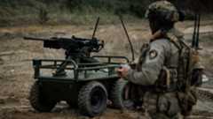 A soldier stands with a military robot in an undisclosed location