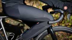 Rider sitting on his top tube wearing Castelli Sorpasso RoS Wind Bib Tights