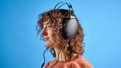 the FiiO JT3 headphones in black and silver shown against a blue tom's guide background