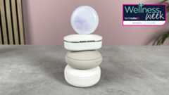 The Loop Dream earplugs case is balanced on top of a stack of other earplugs that have been tested.