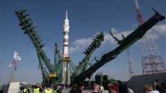 A Russian Soyuz rocket being prepared for a mission at Baikonur cosmodrome in Kazakhstan. The 20-ton service tower is seen opening around the rocket.