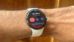 A photo of the Google Pixel Watch 4 showing a Safety Check activity, with an hour left and options to Start Emergency Sharing or Call 911.