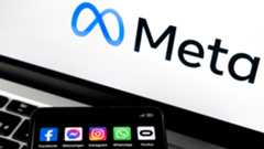 Silhouette of smartphone with Facebook, Messenger, WhatsApp, Instagram, Oculus apps and blurred META logo on background