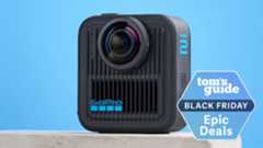 A GoPro MAX2 on a stone surface against a blue background with a Tom's Guide Black Friday deal badge in the bottom right corner of the image.
