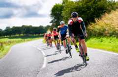 Group of male cyclists on UK country road