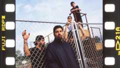 Deftones by a gate in a parking lot in 2000
