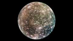 A large rocky moon with various white pockmarks and a gray and blue-green surface glows in the darkness of space