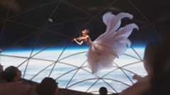 An artist's illustration of a violinist performing in weightlessness inside SpaceX's Big Falcon Rocket. SpaceX CEO Elon Musk says the company will offer a live, high-definition, virtual- reality webcast of its first moon tourist flight.
