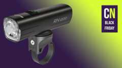 A Magicshine RN1200 from theBlack Friday sales on a Purple and Green cyclingnews background