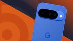 Google Pixel 10 in Indigo blue showing the back cameras and Google G logo on an orange TechRadar logo background, tilted to the right at a slightly jaunty angle