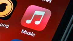 The Apple Music app icon against a red background on an iPhone.