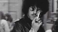 Phil Lynott in sunglasses, smoking a cigarette (1975)