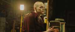 Emma Stone as Michelle with her head shaved in Bugonia