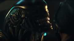 a grinning dome-headed alien predator