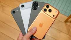 A bunch of iPhones held in the hand.