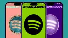 Spotify logos teasing Wrapped 2024 on three iPhones 