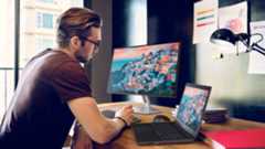 Man using Dell laptop and Dell Monitor