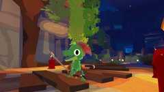 Screenshot from Lil Gator Game: In the Dark, showing a smiling alligator kid wandering around a dark, candle-lit cave.