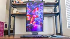 The Lenovo Yoga AIO 27" sitting on a desk with the display in portrait mode.