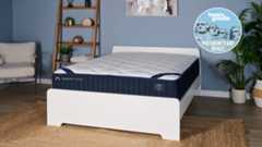 The DreamCloud Classic Hybrid mattress on a white wooden bedframe with a blue Tom's Guide Presidents' Day sales badge overlaid in the top right hand corner
