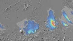 false-color blue and green splotches on a cratered grey surface