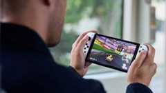 A man uses the Nintendo Switch OLED having found a Nintendo Switch OLED restock