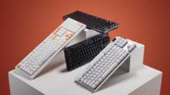 Selection of gaming keyboards on a white plinth with an orange background