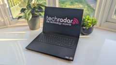 The Razer Blade 16 photographed for TechRadar on a white surface with plants in the background.