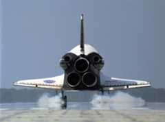 Seen from behind, space shuttle Discovery kicks up dust as it touches down on Runway 33 of the Shuttle Landing Facility at NASA's Kennedy Space Center to complete the 15-day mission STS-120 on Nov. 7, 2007.