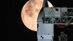 NASA's Artemis 2 moon rocket in front of a full moon