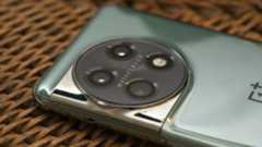 OnePlus 11 in green on wicker basket top with screen on