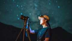 woman photographing the night sky with one of the best astrophotography cameras