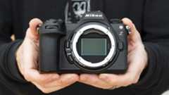 Nikon Z6 III camera in the hand with no lens attached and full-frame sensor on display