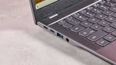 Close-up of left-side ports on Acer Chromebook Plus 516, open on desk with pink background