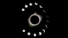 during a total solar eclipse the sun appears as a dark spot with bright white light beaming out from behind. A series of phases surround the main eclipse image, showing the moon take a progressively bigger "bite" out of the sun. 