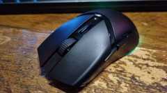 A Razer Cobra HyperSpeed gaming mouse on a wooden desk