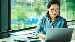 A woman uses one of the best PDF editors on a laptop