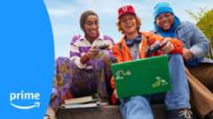 Three college students, two holding a Lune wireless controller and one holding a green laptop.