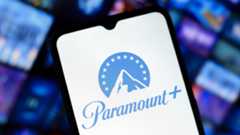 Paramount Plus logo on a smartphone screen with content library shown in the background. 