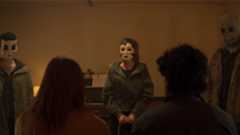 The Strangers standing in a line confronting their captives