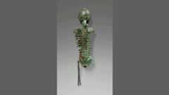 a bronze human skeleton that rotates to show four sides