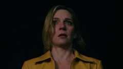 Rhea Seehorn as Carol Sturka, looking scared, in Pluribus.