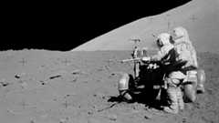 A black and white photo of an astronaut on the moon.