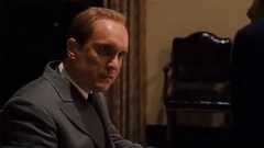 Robert Duvall in a suit looking serious in The Godfather